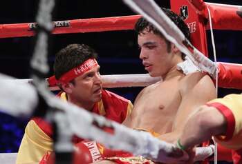 LOS ANGELES, CA - JUNE 04:  Strength and conditioning coach Alex Ariza talks with Julio Cesar Chavez Jr. of Mexico between rounds against Sebastian Zbik of Germany during their WBC World Middleweight Title bout at Staples Center on June 4, 2011 in Los Ang