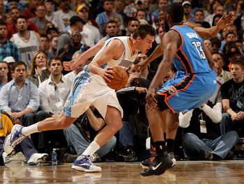 DENVER, CO - APRIL 25:  Danilo Gallinari #8 of the Denver Nuggets drives the ball against Kevin Durant #35 and James Harden #13 of the Oklahoma City Thunder in Game Four of the Western Conference Quarterfinals in the 2011 NBA Playoffs at Pepsi Center on A