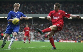 LIVERPOOL, ENGLAND - JANUARY 1: John Arne Riise of Liverpool attempts to shoot past Damien Duff of Chelsea during the Barclays Premiership match between Liverpool and Chelsea at Anfield on January 1, 2005 in Liverpool, England.  (Photo by Clive Brunskill/