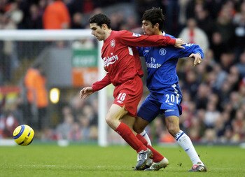 LIVERPOOL, ENGLAND - JANUARY 1: Antonio Nunez of Liverpool (L) and Paulo Ferreira of Chelsea challenge for the ball during the FA Barclays Premiership match between Liverpool and Chelsea at Anfield on January 1, 2005 in Liverpool, England.  (Photo by Matt