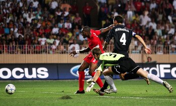 MONTE CARLO, MONACO - AUGUST 26:  Djibril Cisse of Liverpool shoots past Igor Akinfeev the CSKA Moscow goalkeeper to score his first goal during the UEFA Super Cup match between Liverpool and CSKA Moscow at the Stade Louis II on August 26, 2005 in Monte C
