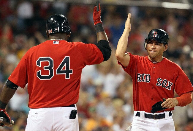 BOSTON, MA - JULY 22:  Jacoby Ellsbury #2 of the Boston Red Sox is congratulated by teammate David Ortiz #34 after Ellsbury scored in the seventh inning against the Seattle Mariners on July 22, 2011 at Fenway Park in Boston, Massachusetts.  (Photo by Elsa