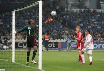 ATHENS, GREECE - MAY 23:  Dirk Kuyt (C) of Liverpool heads a late consolation goal past Dida (L) of Milan during the UEFA Champions League Final match between Liverpool and AC Milan at the Olympic Stadium on May 23, 2007 in Athens, Greece.  (Photo by Laur