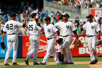NEW YORK, NY - JULY 31:  Mariano Rivera #42 of the New York Yankees is congratulated by his teammates after he pitches in the ninth inning against the Baltimore Orioles on July 31, 2011 at Yankee Stadium in the Bronx borough of New York City. The Yankees