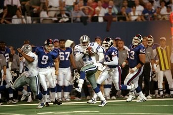 21 Sep 1998:  Kick returner Deion Sanders #21 of the Dallas Cowboys returns a punt for a touchdown during the game against the New York Giants at the Giants Stadium in East Rutherford, New Jersey. The Cowboys defeated the Giants 34-7. Mandatory Credit: Ez
