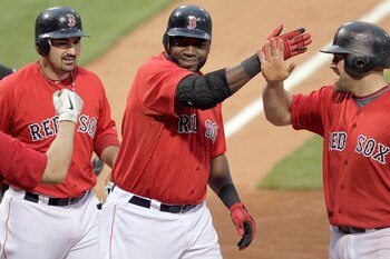 BOSTON, MA - JULY 8:  David Ortiz #34 of the Boston Red Sox celebrates with teammates Kevin Youkilis #20 and Adrian Gonzalez #28 after hitting a three-run home run off of Zach Britton #53 of the Baltimore Orioles in the first inning at Fenway Park on July
