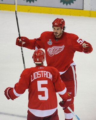 DETROIT - JUNE 12:  Jonathan Ericsson #52 of the Detroit Red Wings celebrates his goal in the third period against the Pittsburgh Penguins with Nicklas Lidstrom #5 during Game Seven of the 2009 NHL Stanley Cup Finals at Joe Louis Arena on June 12, 2009 in
