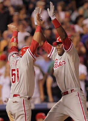 DENVER, CO - AUGUST 01:  John Mayberry Jr. #15 of the Philadelphia Phillies celebrates his pinch hit two run homerun with Carlos Ruiz #51 of the Philadelphia Phillies, who scored on the play, off of Huston Street #16 of the Colorado Rockies to tie the sco