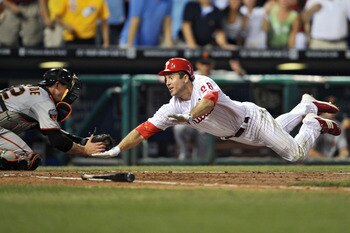 PHILADELPHIA, PA - JULY 26: Chase Utley #26 of the Philadelphia Phillies slides safely past Eli Whiteside #22 of the San Francisco Giants for an inside the park home-run at Citizens Bank Park on July 26, 2011 in Philadelphia, Pennsylvania. (Photo by Drew