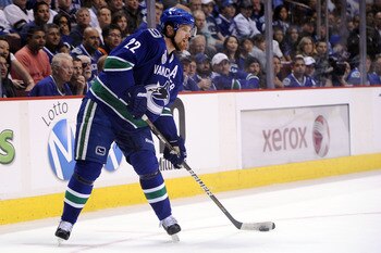 VANCOUVER, BC - JUNE 01:  Daniel Sedin #22 of the Vancouver Canucks looks for the puck against the Boston Bruins during game one of the 2011 NHL Stanley Cup Finals at Rogers Arena on June 1, 2011 in Vancouver, Canada.  (Photo by Harry How/Getty Images)