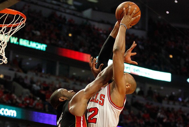 CHICAGO, IL - MAY 15:  Taj Gibson #22 of the Chicago Bulls dunks against Dwyane Wade #3 of the Miami Heat in Game One of the Eastern Conference Finals during the 2011 NBA Playoffs on May 15, 2011 at the United Center in Chicago, Illinois. The Bulls won 10