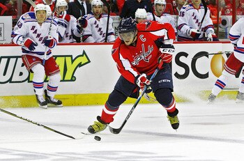 WASHINGTON , DC - APRIL 23:  Alex Ovechkin #8 of the Washington Capitals skates the puck across the blue line against the New York Rangers in Game Five of the Eastern Conference Quarterfinals during the 2011 NHL Stanley Cup Playoffs at the Verizon Center