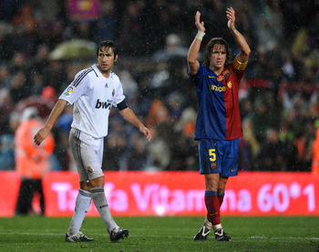 BARCELONA, SPAIN - DECEMBER 13: Carles Puyol (R) of Barcelona celebrates his team's victory flanked by Real Madrid team captain Raul Gonzalez during the La Liga match between Barcelona and Real Madrid at the Camp Nou Stadium on December 13, 2008 in Barce