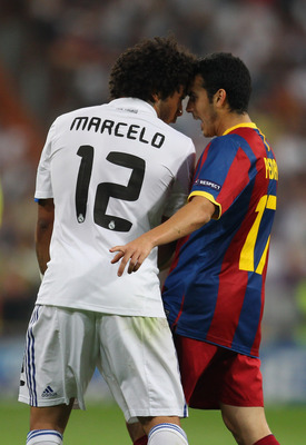 MADRID, SPAIN - APRIL 27: Marcelo of Real Madrid and Pedro Rodriguez of Barcelona clash during the UEFA Champions League Semi Final first leg match between Real Madrid and Barcelona at Estadio Santiago Bernabeu on April 27, 2011 in Madrid, Spain. (Photo