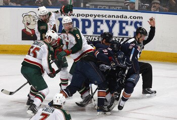 EDMONTON, CANADA - JANUARY 18: Magnus Paajarvi #91 and Taylor Hall #4 of the Edmonton Oilers collide with Mikko Koivu #9, Nick Schultz #55 and Brent Burns #8 of the Minnesota Wild as well as linesmen Bryan Pancich #94 at Rexall Place January 18, 2011 in E
