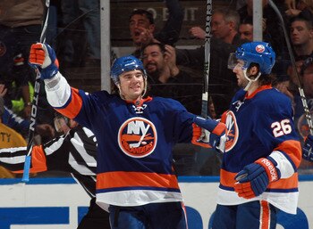 UNIONDALE, NY - MARCH 31: P.A. Parenteau #15 of the New York Islanders celebrate a goal by Matt Moulson #26 of the New York Islanders at 8:38 of the third period against the New York Rangers at the Nassau Coliseum on March 31, 2011 in Uniondale, New York.
