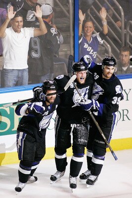 TAMPA, FL - MAY 25:  Martin St. Louis #26 celebrates his third period goal with Steven Stamkos #91 and Mike Lundin #39 of the Tampa Bay Lightning in Game Six of the Eastern Conference Finals against the Boston Bruins during the 2011 NHL Stanley Cup Playof