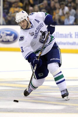 BOSTON, MA - JUNE 13:  Kevin Bieksa #3 of the Vancouver Canucks takes a shot against the Boston Bruins during Game Six of the 2011 NHL Stanley Cup Final at TD Garden on June 13, 2011 in Boston, Massachusetts.  (Photo by Harry How/Getty Images)