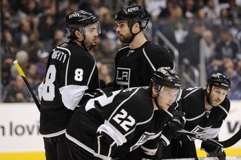 LOS ANGELES, CA - APRIL 25:  Drew Doughty #8 speaks with Willie Mitchell #33 of the Los Angeles Kings in the first period of game six of the Western Conference Quarterfinals against the San Jose Sharks during the 2011 NHL Stanley Cup Playoffs at Staples C
