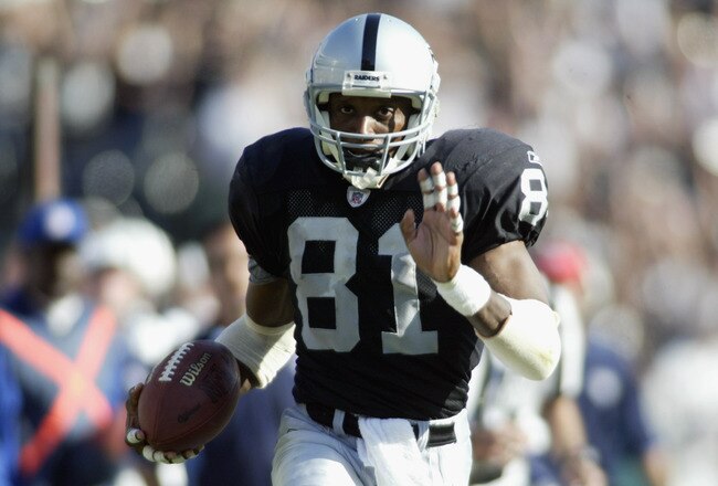 OAKLAND, CA - SEPTEMBER 29:  Tim Brown #81 of the Oakland Raiders runs for a touchdown against the Tennesse Titans during the NFL game at the Network Associates Coliseum on September 29, 2002 in Oakland, California.  The Raiders defeated the Titans 52-25.