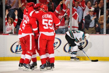 DETROIT - MAY 4:  The Detroit Red Wings celebrate a second period power play goal by Pavel Datsyuk #13 of the Detroit Red Wings as Dan Boyle #22 of the San Jose Sharks skates by in Game Three of the Western Conference Semifinals during the 2011 NHL Stanle