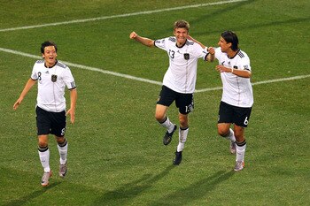 BLOEMFONTEIN, SOUTH AFRICA - JUNE 27:  Thomas Mueller (C) of Germany celebrates scoring with team mates Mesut Oezil (L) and Sami Khedira during the 2010 FIFA World Cup South Africa Round of Sixteen match between Germany and England at Free State Stadium o
