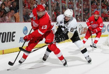 DETROIT - JUNE 02:  Pavel Datsyuk #13 of the Detroit Red Wings skates with the puck past Sidney Crosby #87 of the Pittsburgh Penguins during game five of the 2008 NHL Stanley Cup Finals at Joe Louis Arena on June 2, 2008 in Detroit, Michigan.  (Photo by B
