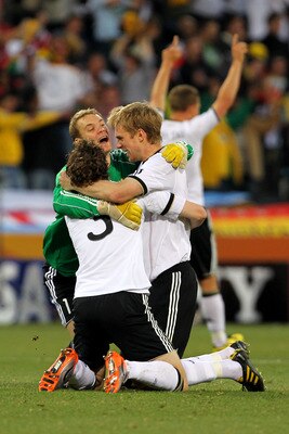 BLOEMFONTEIN, SOUTH AFRICA - JUNE 27:  Manuel Neuer of Germany celebrates with team mates Per Mertesacker and Arne Friedrich during the 2010 FIFA World Cup South Africa Round of Sixteen match between Germany and England at Free State Stadium on June 27, 2