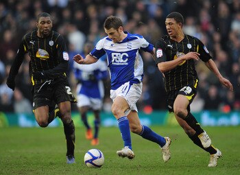 BIRMINGHAM, ENGLAND - FEBRUARY 19:  David Bentley of Birmingham City is challenged by Reda Johnson (22) and Liam Palmer (29) of Sheffield Wednesday during the FA Cup Sponsored by e.on 5th Round match between Birmingham City and Sheffield Wednesday at St A