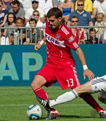 VANCOUVER, CANADA - AUGUST 7: Jonathan Leathers #25 of the Whitecaps FC ftries to tackle Gonzalo Segares #13 of the Chicago Fire during the second half of MLS Soccer on August 07, 2011 at Empire Field in Vancouver, BC, Canada.  (Photo by Rich Lam/Getty Im