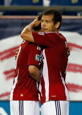FOXBORO, MA - AUGUST 6:  Alejandro Moreno #15 of the Chivas USA celebrates his goal with a teammate at Gillette Stadium on August 6, 2011 in Foxboro, Massachusetts. Caraglio will play his first game for the Revolution. (Photo by Jim Rogash/Getty Images)
