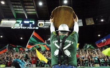 PORTLAND, OR - AUGUST 3: 'Timber Joey' holds up a 'log slab' indicating a Portland Timbers goal as members of the 'Timbers Army' cheer during the second half of the game against the Los Angeles Galaxy at Jeld-Wen Field on August 3, 2011 in Portland, Orego