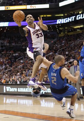 PHOENIX, AZ - MARCH 27:  Grant Hill  #33 of the Phoenix Suns attempts a shot over Jason Kidd #2 of the Dallas Mavericks during the NBA game at US Airways Center on March 27, 2011 in Phoenix, Arizona.  The Mavericks defeated the Suns 91-83.  NOTE TO USER: