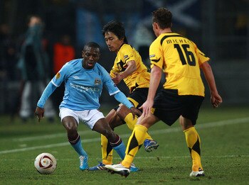 THESSALONIKI, GREECE - FEBRUARY 15:  Daisuke Sakata of Aris (C) battles for the ball with Shaun Wright-Phillips of Machester City during the first leg round of 32 Europa League match between Aris Saloniki and Manchester City  at Kleanthis Vikelidis stadiu
