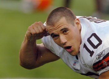 DENVER - AUGUST 25:  Quarterback Brady Quinn #10 of the Cleveland Browns signals to the sidelines about his shaved head as he warms up before the pre-season football game against the Denver Broncos on August 25, 2006 at Invesco Field at Mile High in Denve