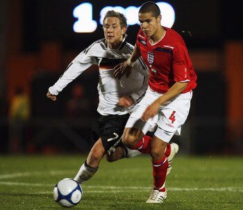 COLCHESTER, UNITED KINGDOM - NOVEMBER 18:  Jack Rodwell of England holds off a tackle from Lewis Holtby of Germany during the International Friendly between England U19 and Germany U19 at the Weston Homes Community Stadium on November 18, 2008 in Colchest