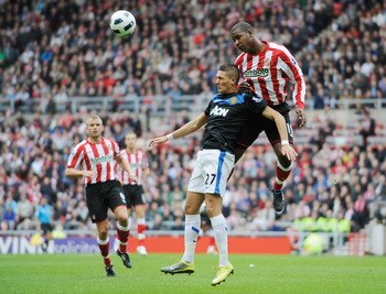 SUNDERLAND, ENGLAND - OCTOBER 02: Titus Bramble of Sunderland challenges Federico Macheda of Manchester United during the Barclays Premier League match between Sunderland and Manchester United at the Stadium of Light on October 2, 2010 in Sunderland, Engl