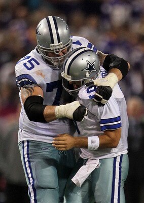 MINNEAPOLIS - OCTOBER 17:  Marc Colombo #75 and Tony Romo #9 of the Dallas Cowboys celebrate during the game against the Minnesota Vikings at Mall of America Field on October 17, 2010 in Minneapolis, Minnesota.  (Photo by Jeff Gross/Getty Images)