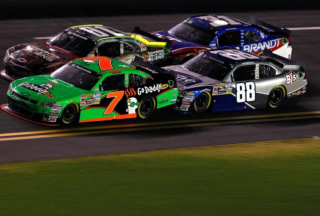 DAYTONA BEACH, FL - JULY 01:  Danica Patrick, driver of the #7 GoDaddy.com Chevrolet, and Aric Almirola, driver of the #88 Suave Men Chevrolet, race during the NASCAR Nationwide Series Subway Jalapeno 250 Powered by Coca-Cola at Daytona International Spee