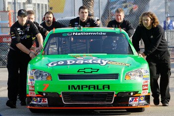 DAYTONA BEACH, FL - FEBRUARY 17:  Danica Patrick, driver of the #7 GoDaddy.com Chevrolet, gets pushed through the garage area by crew members during practice for the NASCAR Nationwide Series DRIVE4COPD 300 at Daytona International Speedway on February 17,