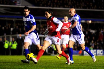 BIRMINGHAM, ENGLAND - JANUARY 01:  Samir Nasri of Arsenal takes a shot on goal as Scott Dann (L) and Stephen Carr (R) of Birmingham close in during the Barclays Premier Leaue match between Birmingham City and Arsenal at St. Andrews on January 1, 2011 in B