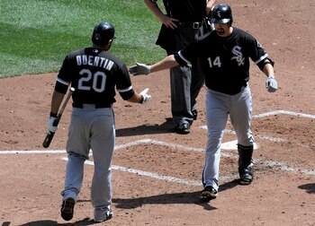 MINNEAPOLIS, MN - AUGUST 7: Carlos Quentin #20 of the Chicago White Sox congratulates Paul Konerko #14 of the Chicago White Sox on a solo home run against the Minnesota Twins in the fourth inning on August 7, 2011 at Target Field in Minneapolis, Minnesota
