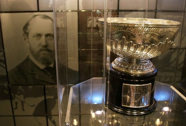 TORONTO, ON - NOVEMBER 09:  The original Stanley Cup with a photo of Lord Stanley of Preston in the background in the vault at the Great Hall at the Hockey Hall of Fame on November 9, 2009 in Toronto, Canada.  (Photo by Bruce Bennett/Getty Images)