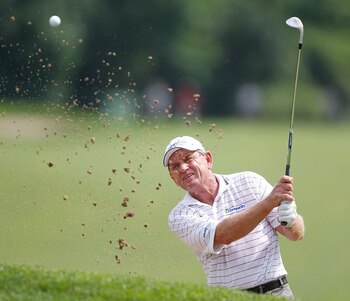 TOLEDO, OH - JULY 29: Nick Price hits from a bunker to the eighth green during the second round of the United States Senior Open at the Inverness Club on July 29, 2011 in Toledo, Ohio.  (Photo by Gregory Shamus/Getty Images)