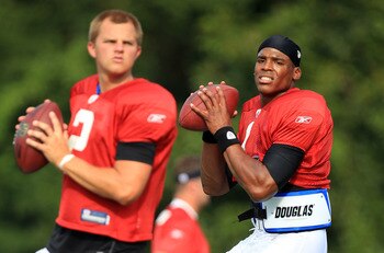 SPARTANBURG, SC - AUGUST 03:  Teammates Jimmy Clausen #2 and Cam Newton #1 of the Carolina Panthers compete in a workout during training camp at Wofford College on August 3, 2011 in Spartanburg, South Carolina.  (Photo by Streeter Lecka/Getty Images)