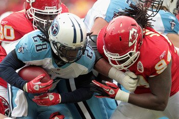 KANSAS CITY, MO - DECEMBER 26: Chris Johnson #28 of the Tennessee Titans carries the ball as Tyson Jackson #94 of the Kansas City Chiefs defends during the game on December 26, 2010 at Arrowhead Stadium in Kansas City, Missouri.  (Photo by Jamie Squire/Ge