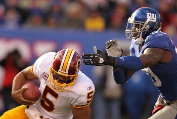 EAST RUTHERFORD, NJ - DECEMBER 05:  Jason Pierre Paul #90 of the New York Giants Sacks Donovan McNabb #5 of the Washington Redskins during their game on December 5, 2010 at The New Meadowlands Stadium in East Rutherford, New Jersey.  (Photo by Al Bello/Ge