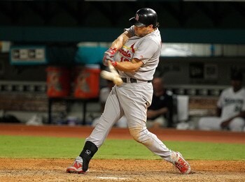 MIAMI GARDENS, FL - AUGUST 05:  Lance Berkman #12 of the St. Louis Cardinals hits an RBI double during a game against the Florida Marlins at Sun Life Stadium on August 5, 2011 in Miami Gardens, Florida.  (Photo by Mike Ehrmann/Getty Images)