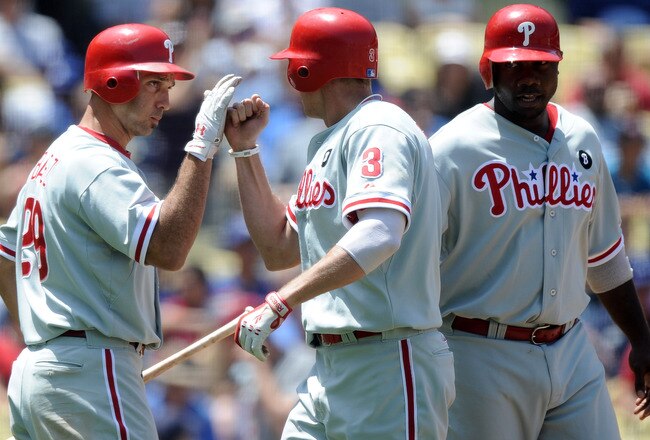 LOS ANGELES, CA - AUGUST 10:  Hunter Pence #3 of the Philadelphia Phillies celebrates his two run homerun with Raul Ibanez #29, and Ryan Howard #6 to trail 5-2 to the Los Angeles Dodgers during the fourth inning at Dodger Stadium on August 10, 2011 in Los
