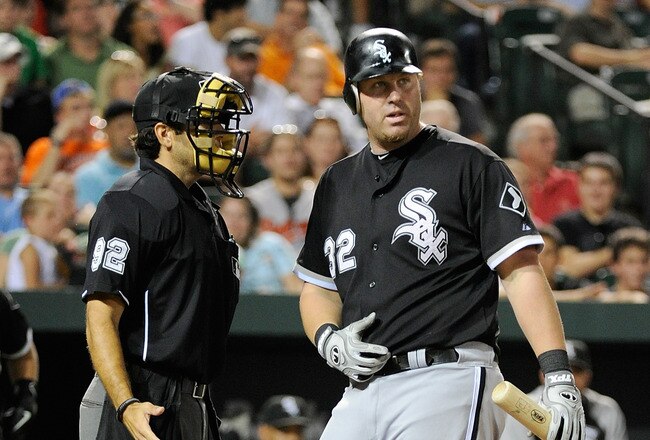 BALTIMORE, MD - AUGUST 10:  Adam Dunn #32 of the Chicago White Sox argues with home plate umpire Bill Miller after striking out in the eighth inning against the Baltimore Orioles at Oriole Park at Camden Yards on August 10, 2011 in Baltimore, Maryland.  (